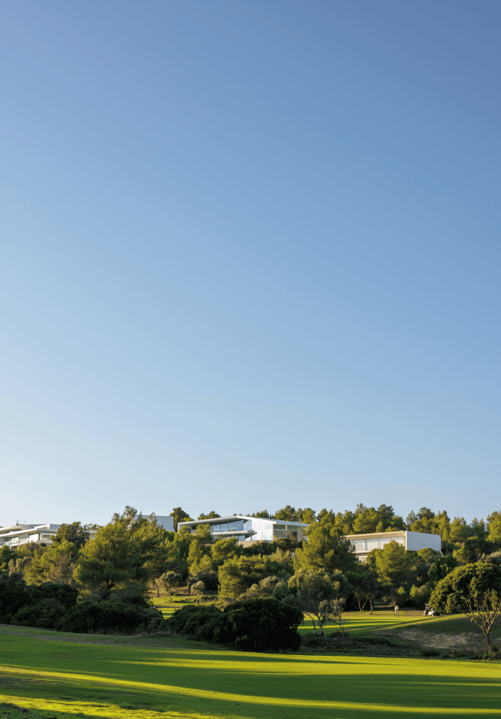 Residências de luxo com vista para o campo de golfe no resort Palmares Algarve, rodeadas por natureza exuberante.